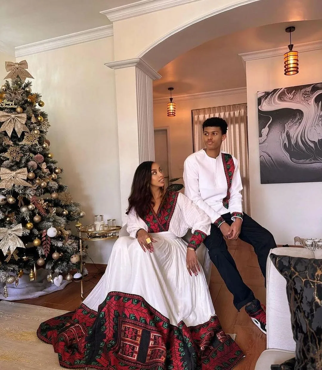 Modern Elegance in Deep Red: Stylish Habesha Couples Outfit for Special Occasions